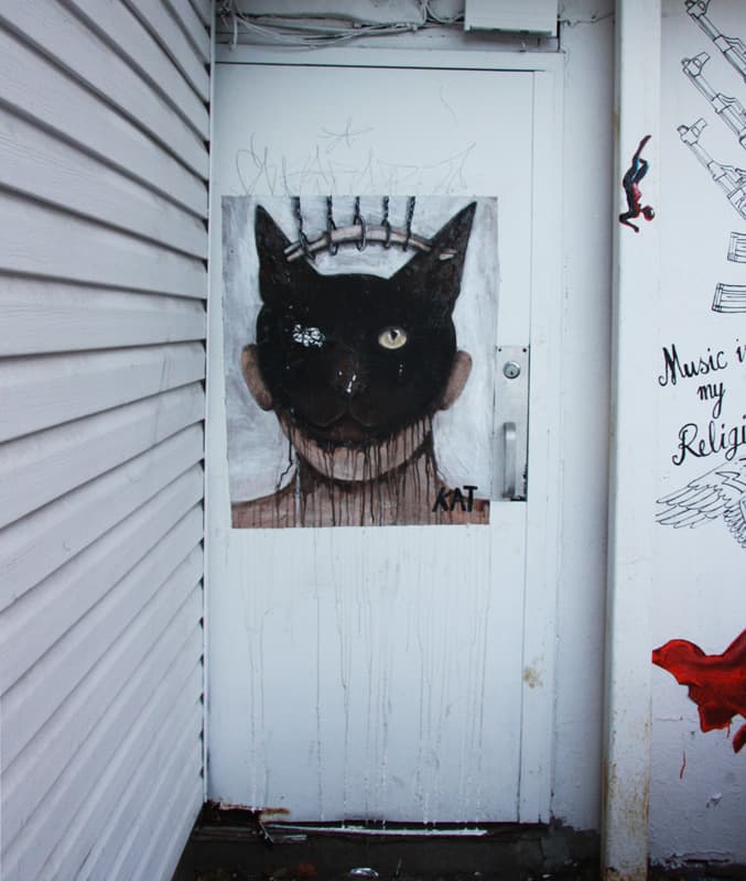 Kat wheatpaste behind the offices of LNDMRK